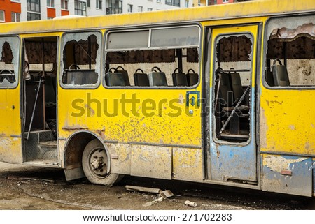 Old dirty yellow bus with broken windows
