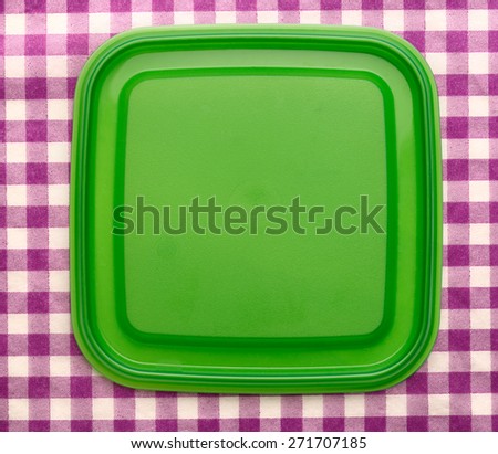 Green square plastic cover on background closeup