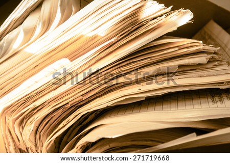 Dirty messy paper documents as background closeup