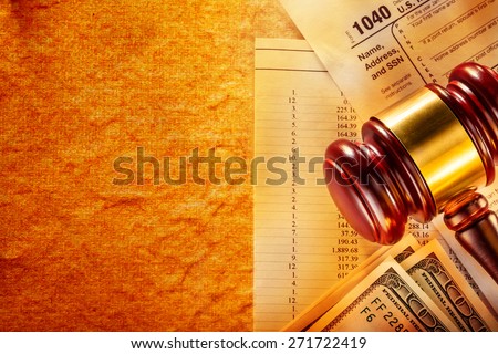 Annual budget, tax form, gavel and dollars
