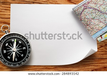 Compass with map on blank piece of paper