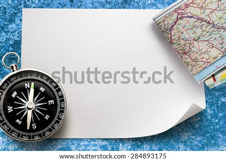 Compass with map on blank piece of paper