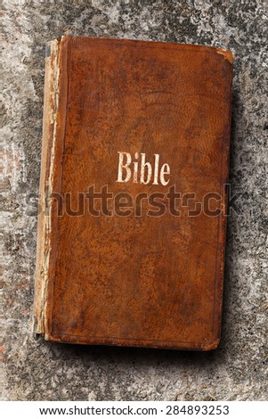 Old Bible book on steel gray background