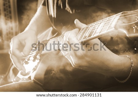 Electric guitar in male hands in closeup