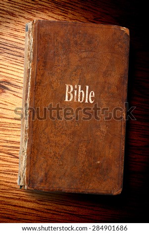 Old Bible book on the wooden background