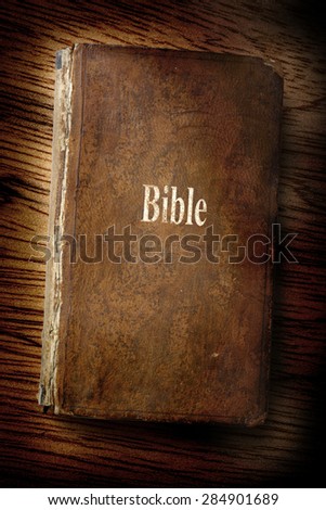 Old Bible book on the wooden background