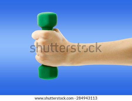 Female hand holding green dumbbell in closeup