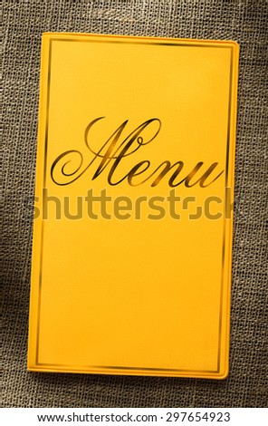 Yellow framed menu book on sack background