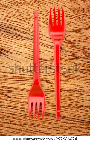 Red plastic forks vertical in close up