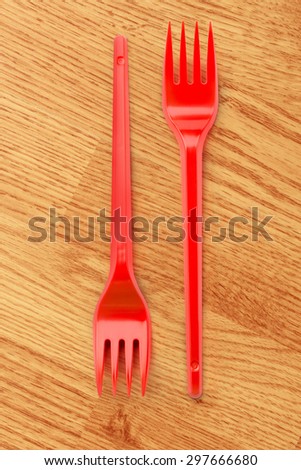 Red plastic forks vertical in close up
