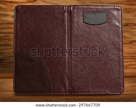 Empty brown folder on wooden background closeup