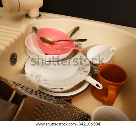Dirty dishes in kitchen sink in closeup