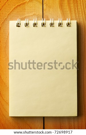 Notepad isolated on wooden background
