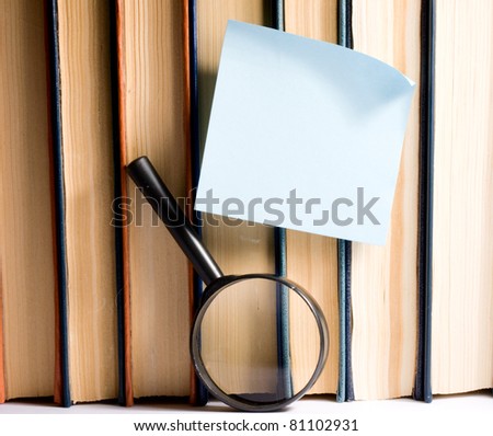 Sticker on books and magnifying glass