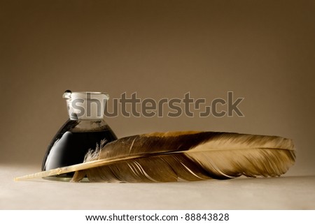 A feather with the bottle full of ink