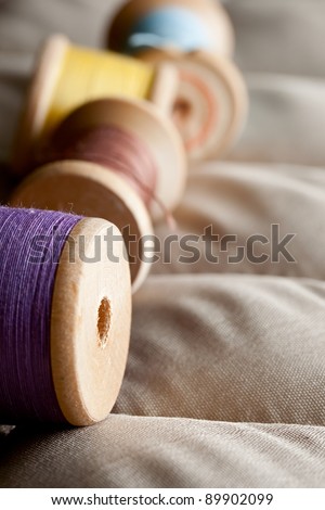 Thread bobbins on a gray fabric