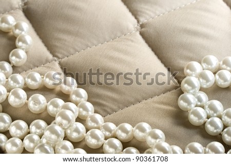 String of pearls on a gray fabric