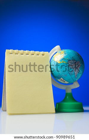 Notepad with globe on a blue-and-white background