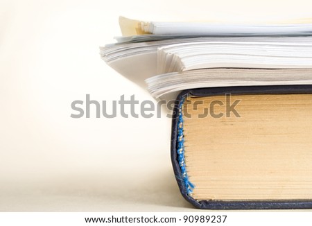 A pile of paper and a book