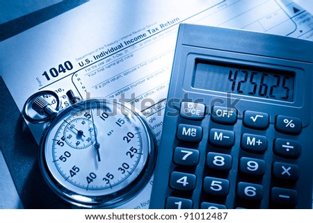 Tax form, stopwatch and calculator