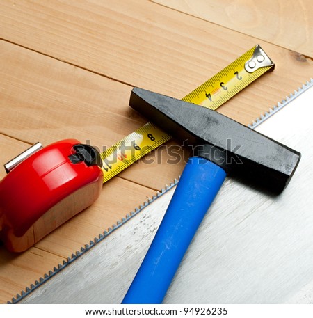 Handsaw, tape measure and hammer