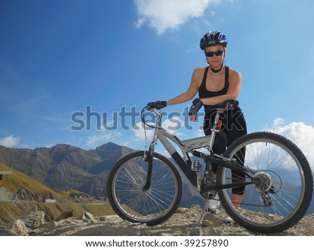 young women prepared for downhill, with full suspension bike