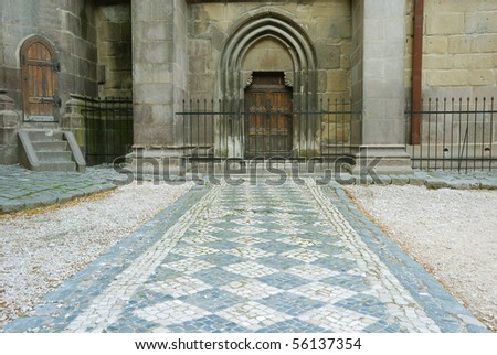 leading lines rock pavement to old medieval building entrance