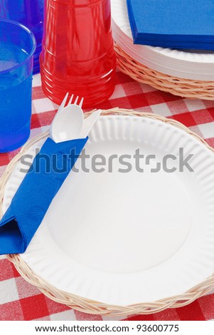 Red, white and blue picnic table setting is ready to celebrate  a festive summer holiday meal.
