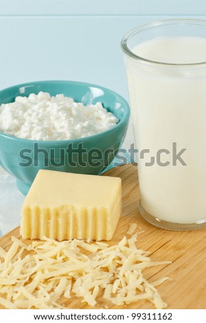 Close up of healthy dairy products includes milk, cottage cheese and shredded Swiss cheese