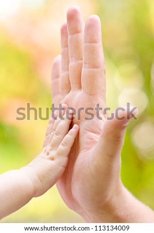 father and child making hi-five gesture