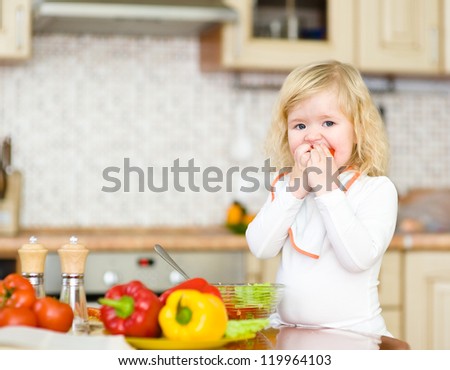 Kid eating healthy vegetables meal in the kitchen
