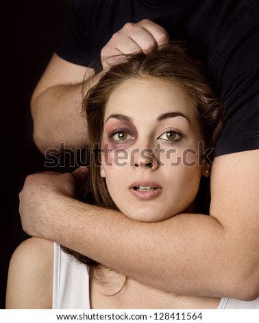 Domestic violence woman being abused and strangled by strong man. on dark background