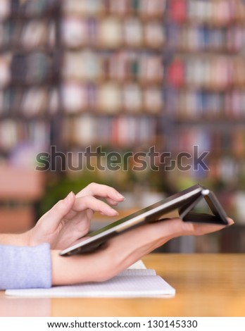 Hands typing on tablet in college class