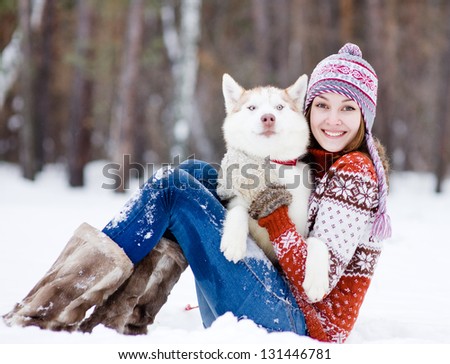 beautiful girl in winter forest with dog