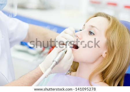 medical dentist procedure of teeth polishing with cleaning from dental deposit