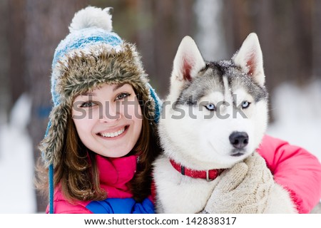 Portrait of a pretty young woman with her pet dog