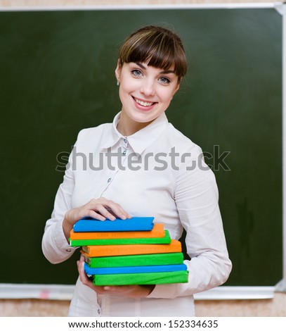 portrait of young teacher with books