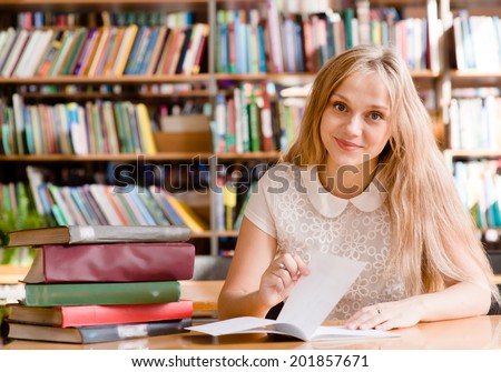 woman writes notes in the library