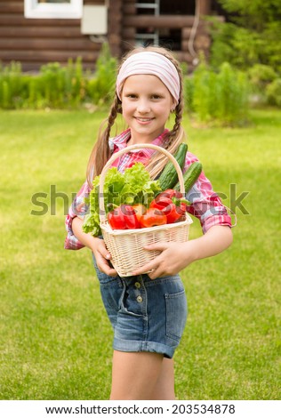 young girl with vegetables in basket