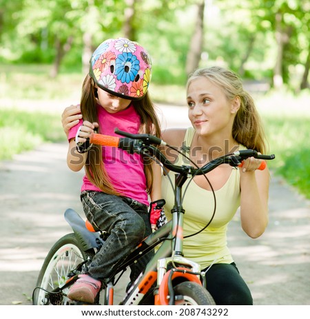 young mother calms the sad daughter who did not get to ride a bike
