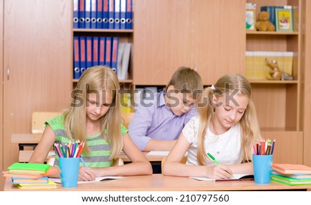 Group of elementary school pupils takes the test in class