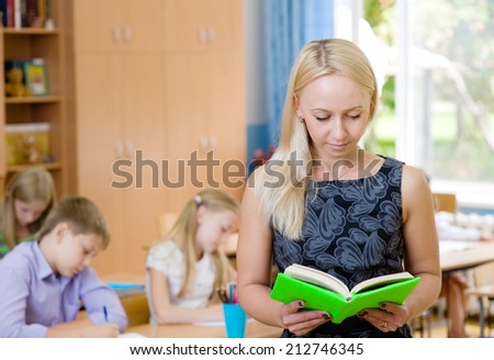 Portrait of a teacher on a background of pupils