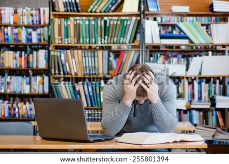 Sad male student in the university library