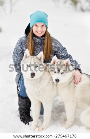 portrait of a young girl with a husky puppies