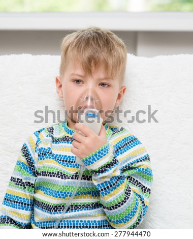 sick little boy makes inhalation home