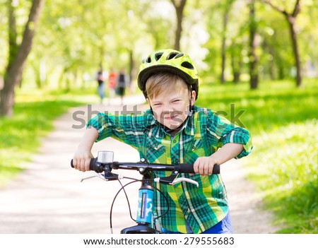 Funny child learns to ride a bike