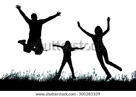 Silhouette of a happy active family jumping at sunset.