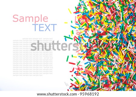 Border made of little colorful candy isolated on white background  with sample text