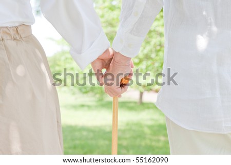 Elderly couple who grips walking stick