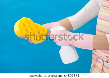 Woman spraying cleaning sponge